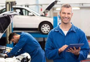 Smiling mechanic using a tablet pc at the repair garage-557690-edited.jpeg
