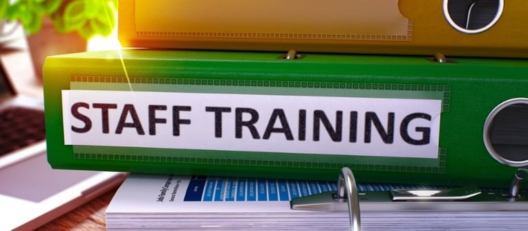 Staff Training - Green Office Folder on Background of Table with Stationery - staff training needed for 457 visa